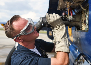 Enlisted team member inspects F/A-18 jet