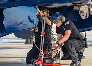 Enlisted team member inspects F/A-18 jet