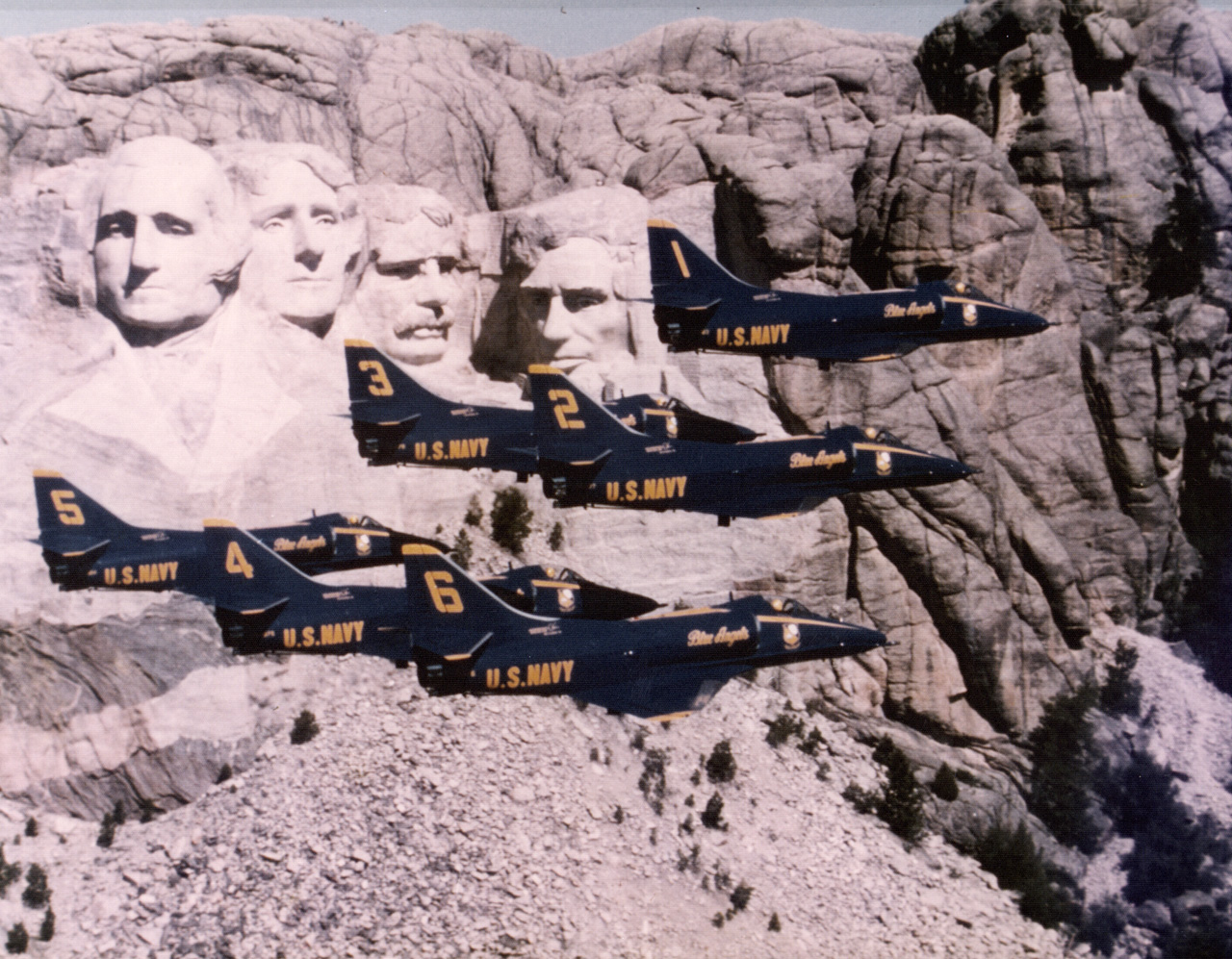<em>The Blue Angels fly their Skyhawks in close formation past Mount Rushmore (U.S. Navy)</em>